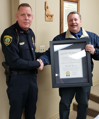 Peace Officer Standards and Training Division Director Brad Johnson (l) presents Mountain Home Police Department Chief Scott Conner with the Idaho POST Executive Certificate, the highest certification an officer can receive in Idaho.